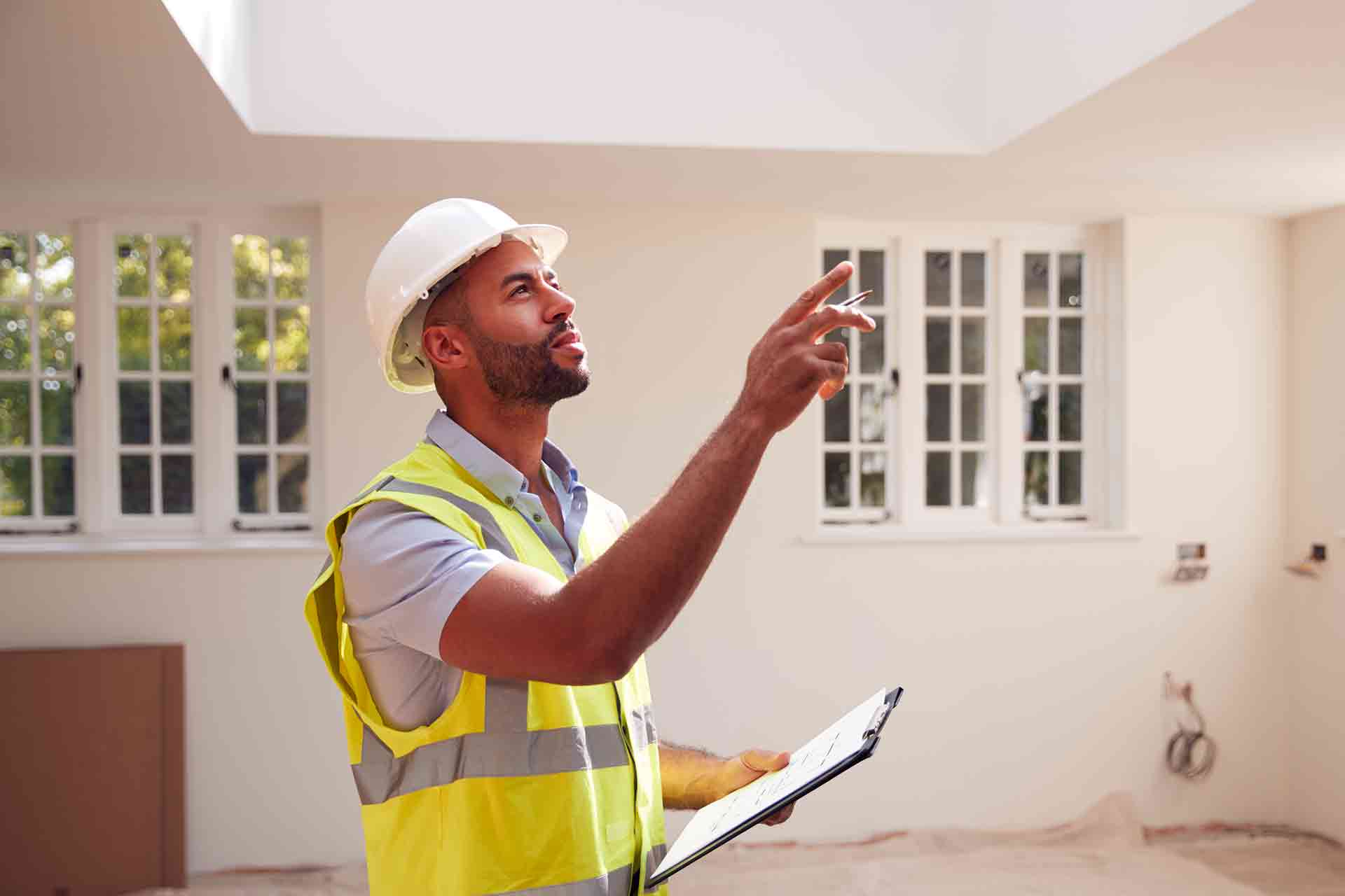Third Party Wall Surveyors Stockport reviewing plans between two parties during a dispute